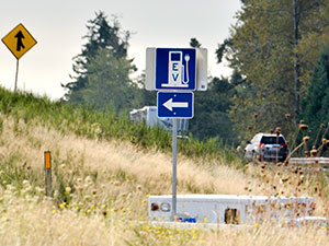 electric vehicle charging station sign with a directional arrow