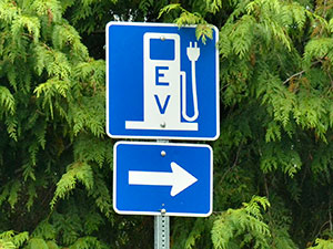 electric vehicle charging station sign with a directional arrow